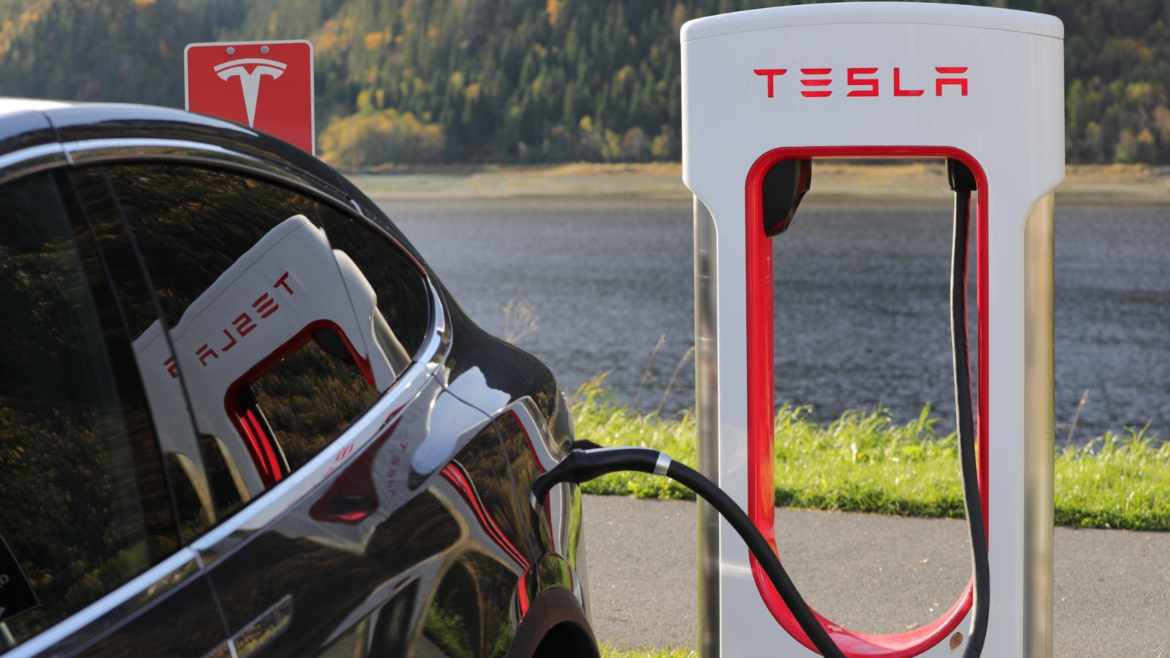 Tesla Supercharger hub bustling with electric vehicles.